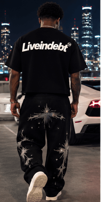 Liveindebt starburst rhinestone sweatpants against the Atlanta skyline